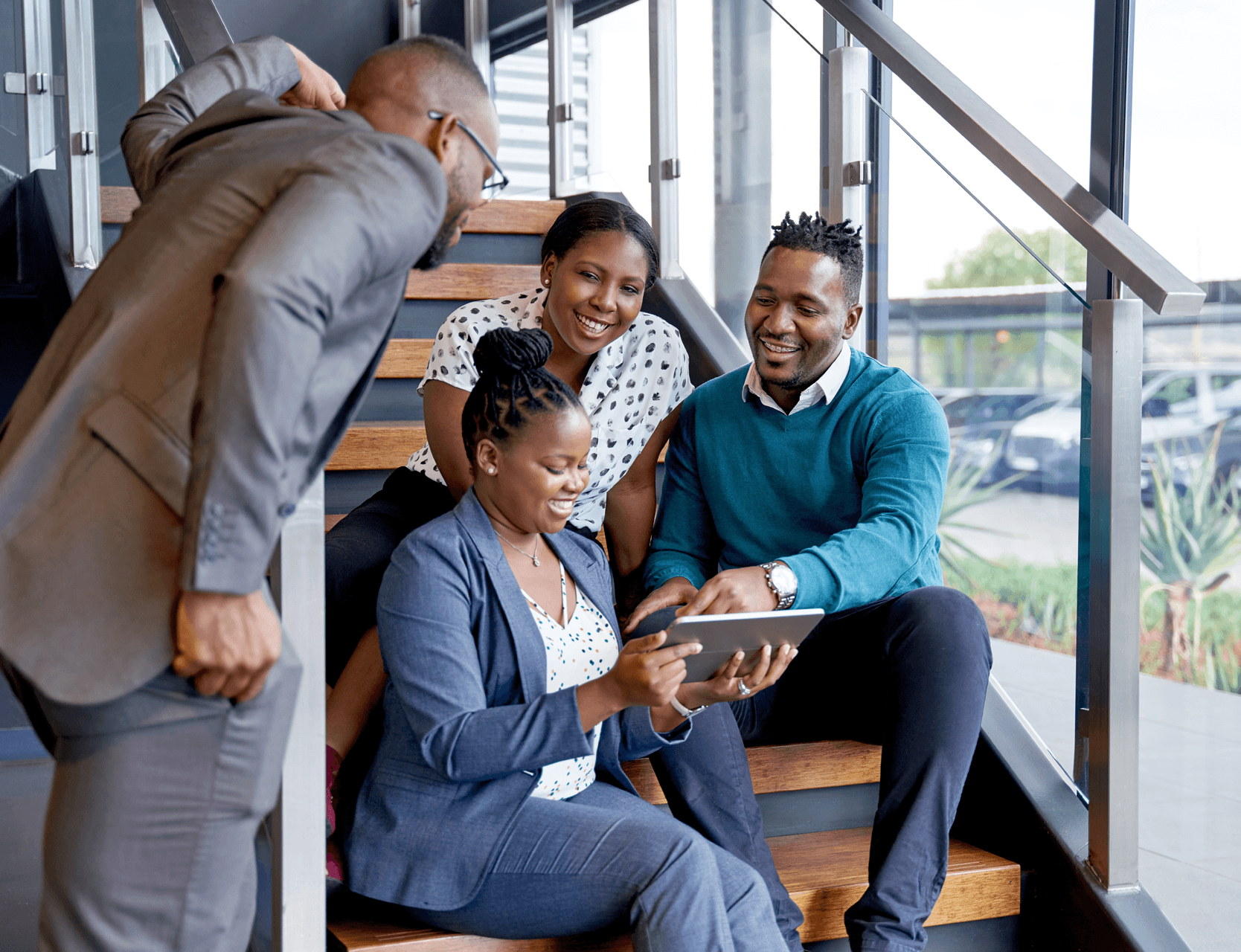 Colleagues discussing work in an office seating area