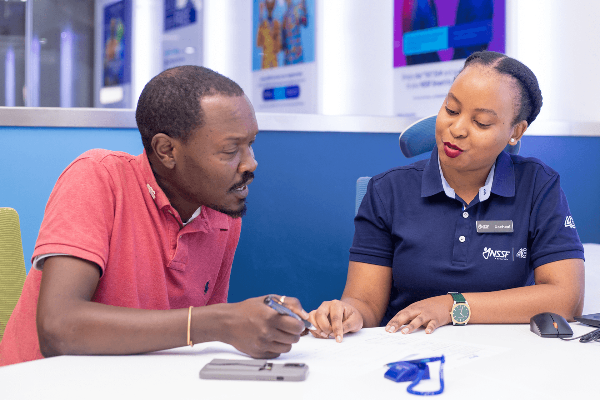 An NSSF employee assisting a member at a branch