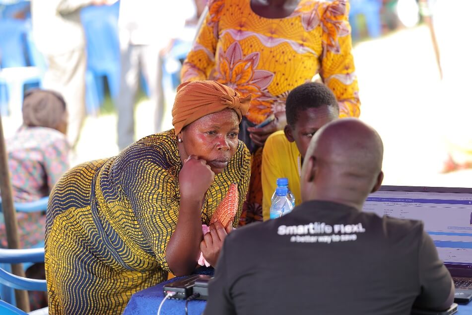 An NSSF employee engages a member in Sironko on the benefits of Smartlife Flexi.