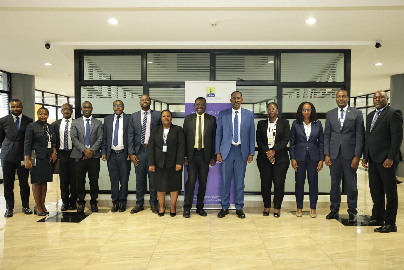 NSSF employees, led by Managing Director Patrick Ayota (centre-left), meet with Uganda Revenue Authority representatives, led by Commissioner General John Musinguzi Rujoki (centre-right), to strengthen collaboration between the two organisations.