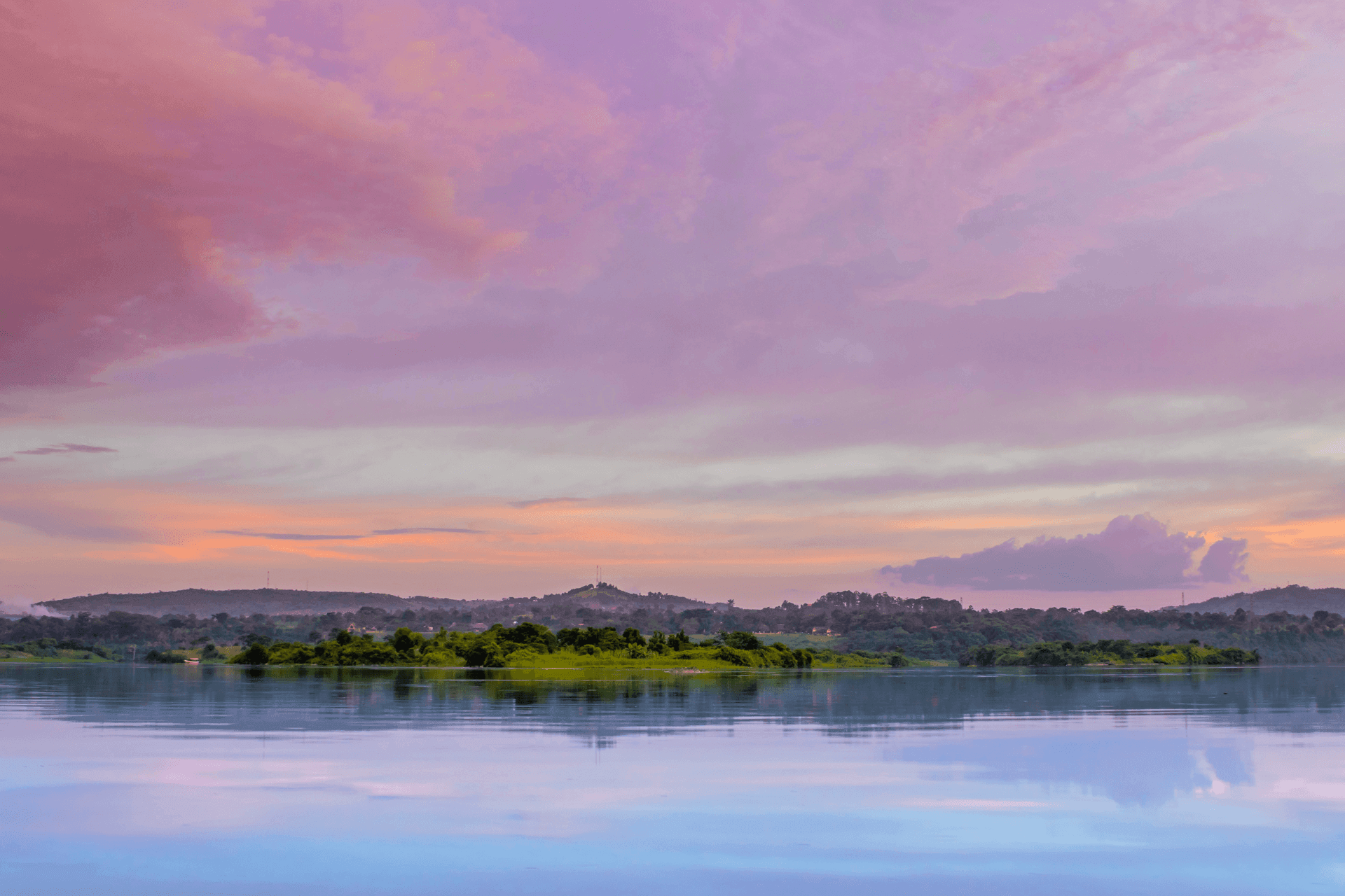 Calm water reflecting a purple evening sky