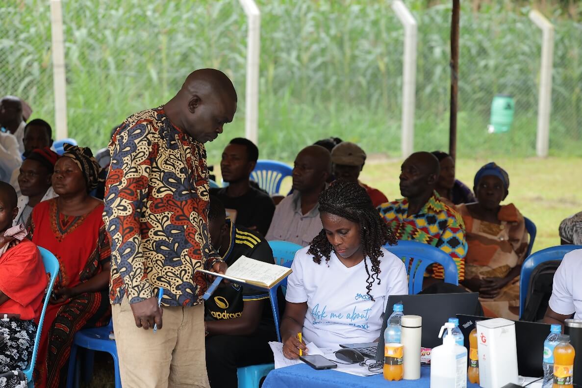 An NSSF employee assists a customer during an outreach activity in Bududa District, Eastern Uganda.