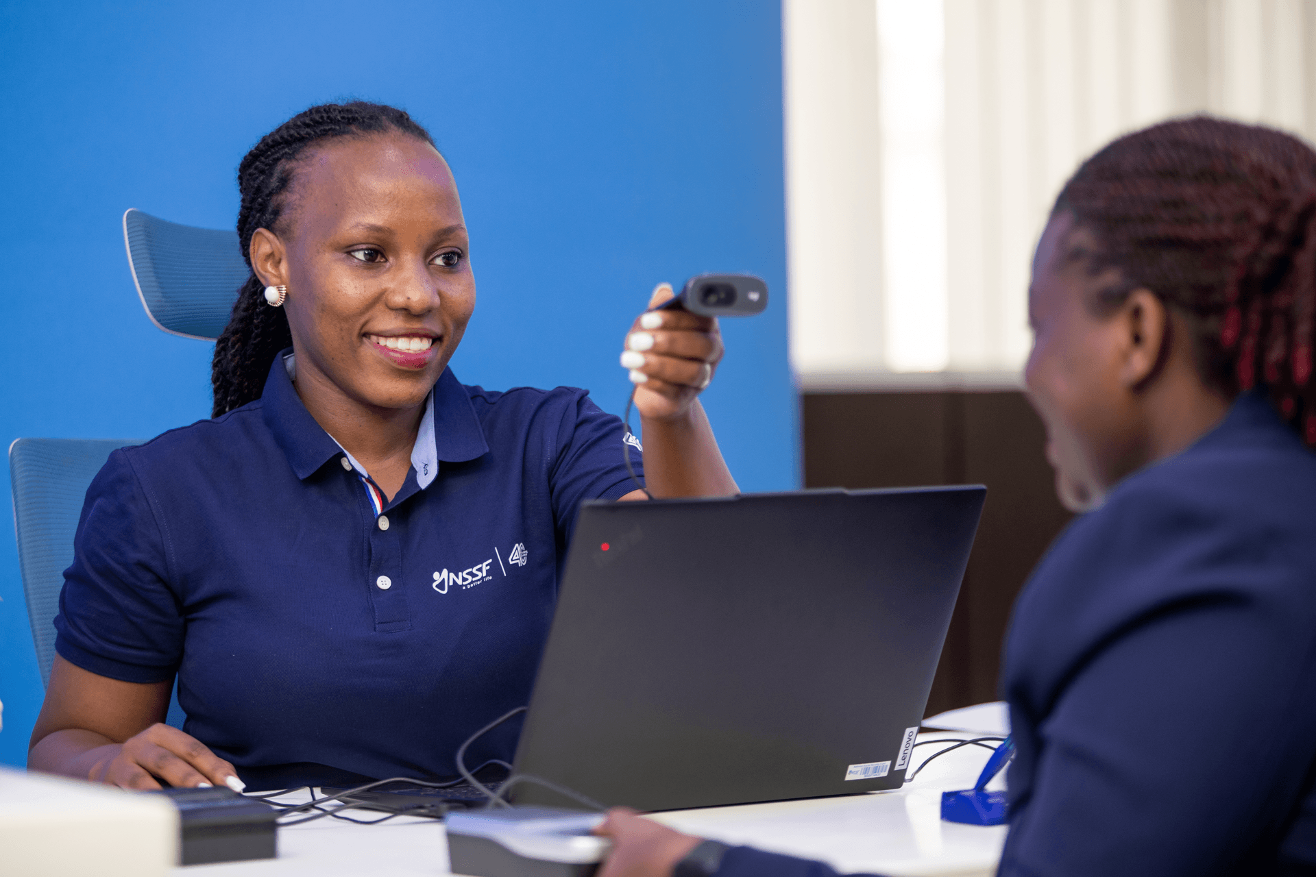 NSSF staff member assisting a visitor