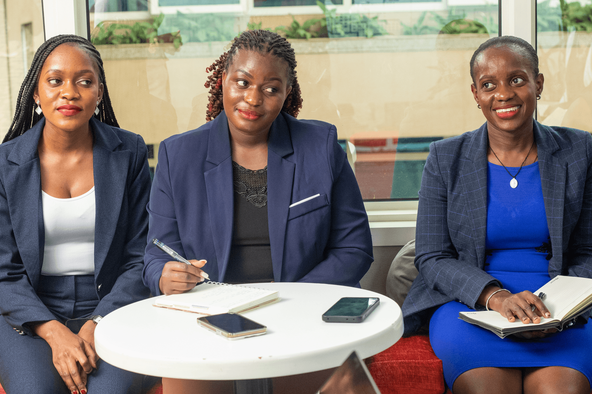 Three women in discussion around a table