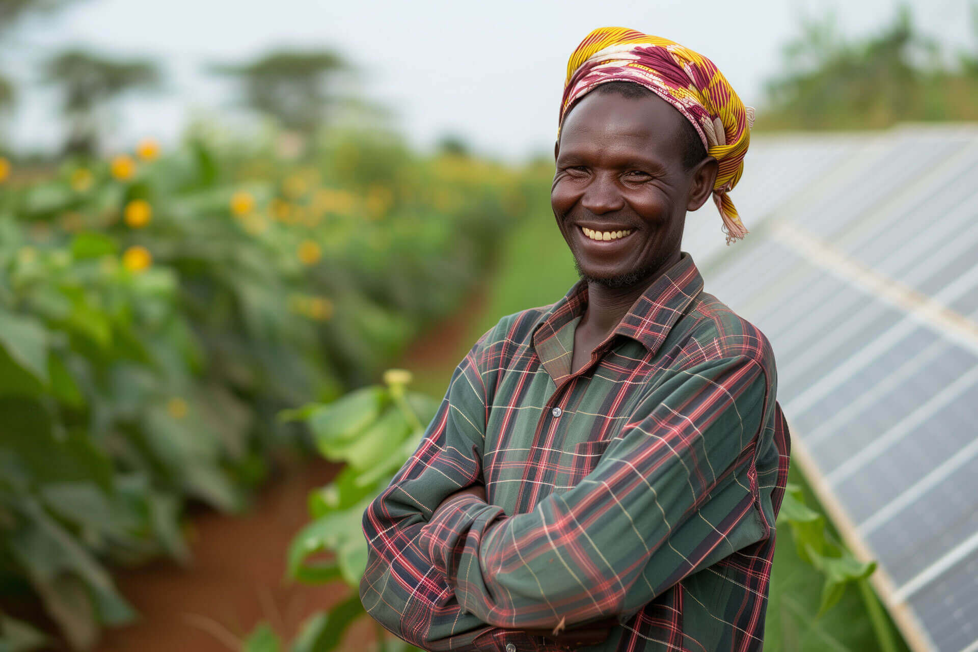 Smiling farmer beside a greenhouse