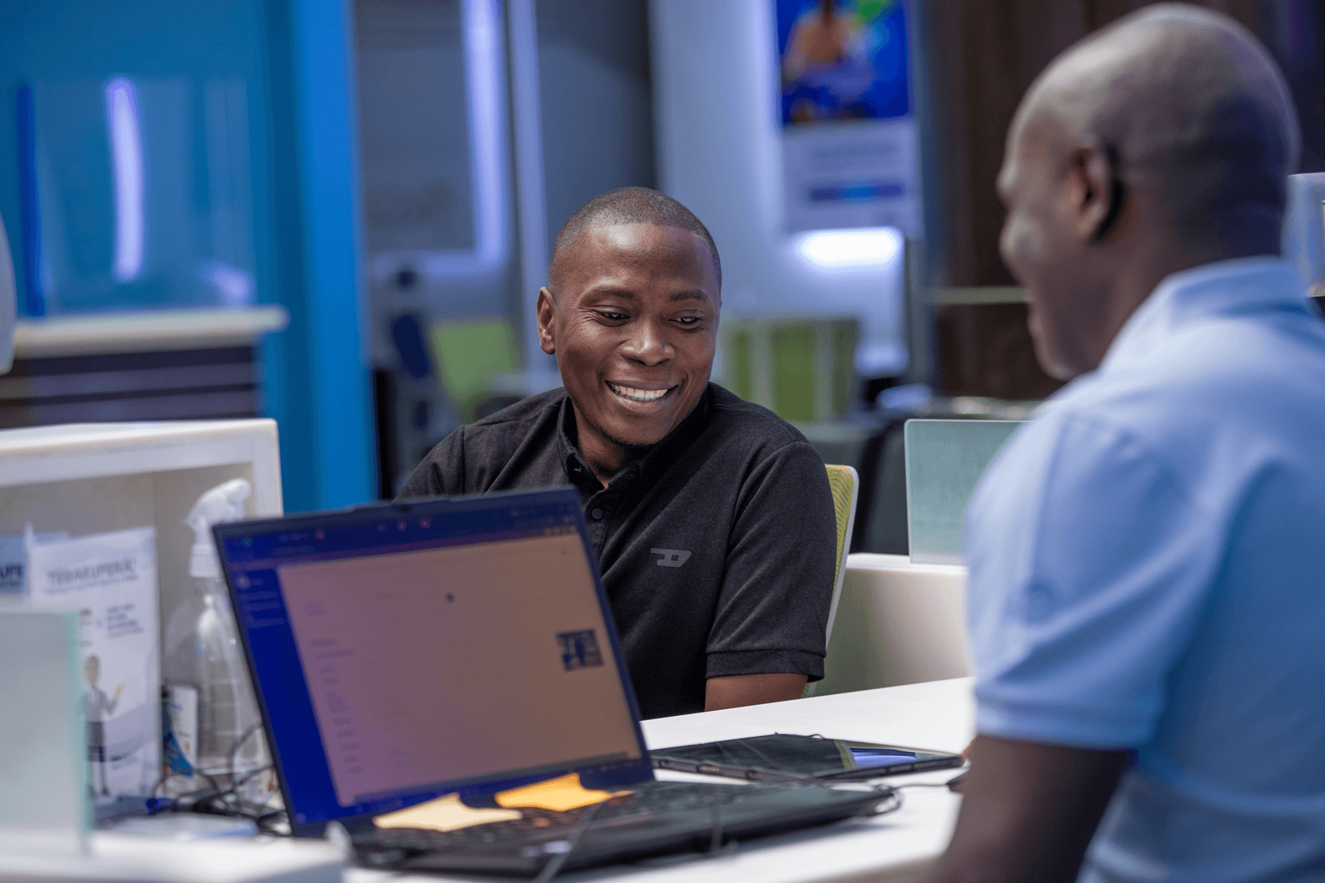 NSSF staff member assisting a visitor at a desk